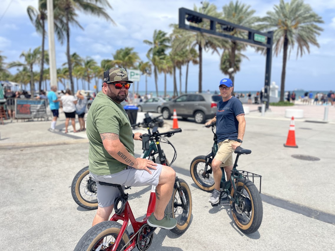 Two riders on EzeBike electric bike rentals at Fort Lauderdale beach