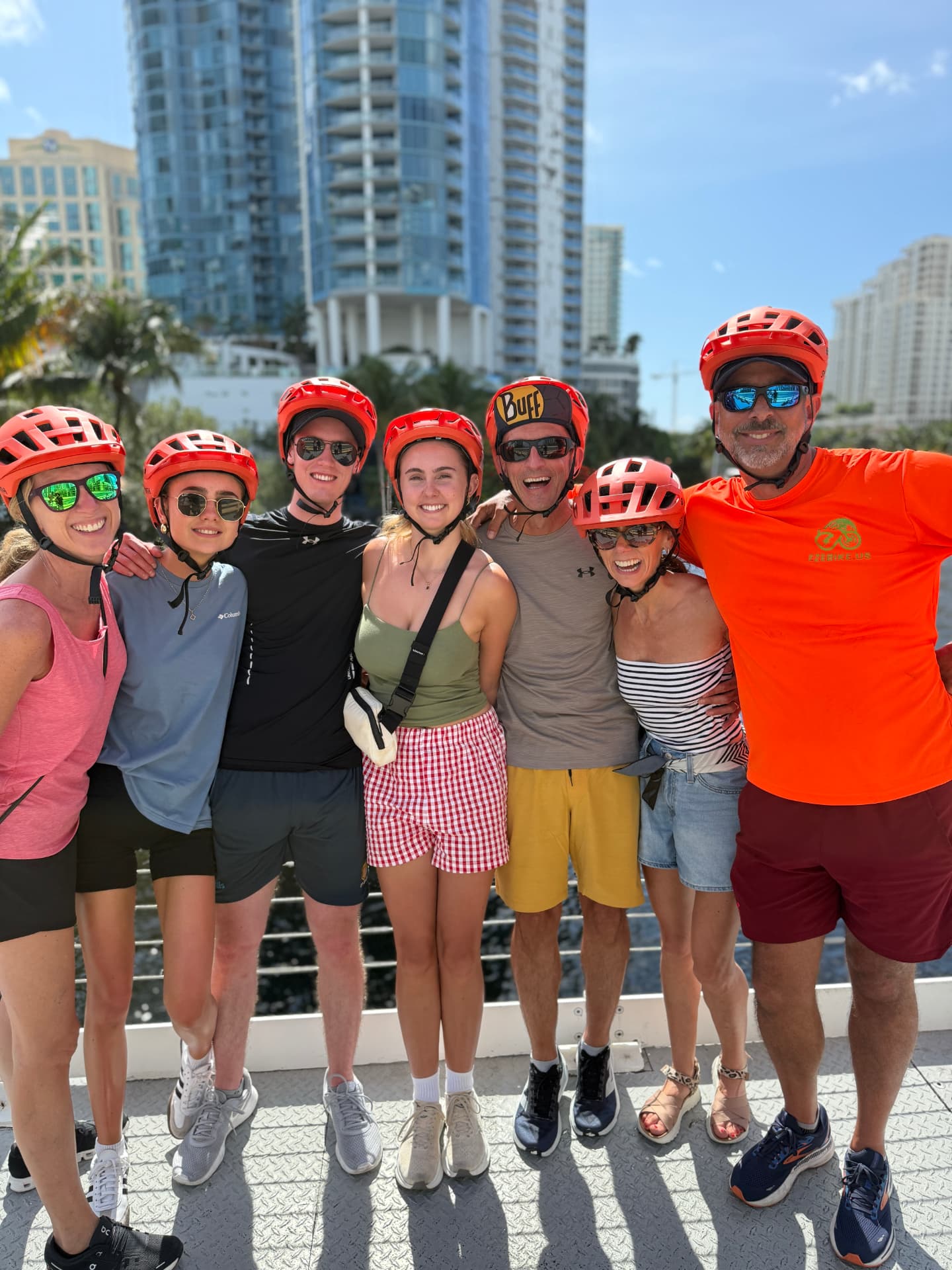 Happy guests on a guided eBike tour with Fort Lauderdale skyline behind them