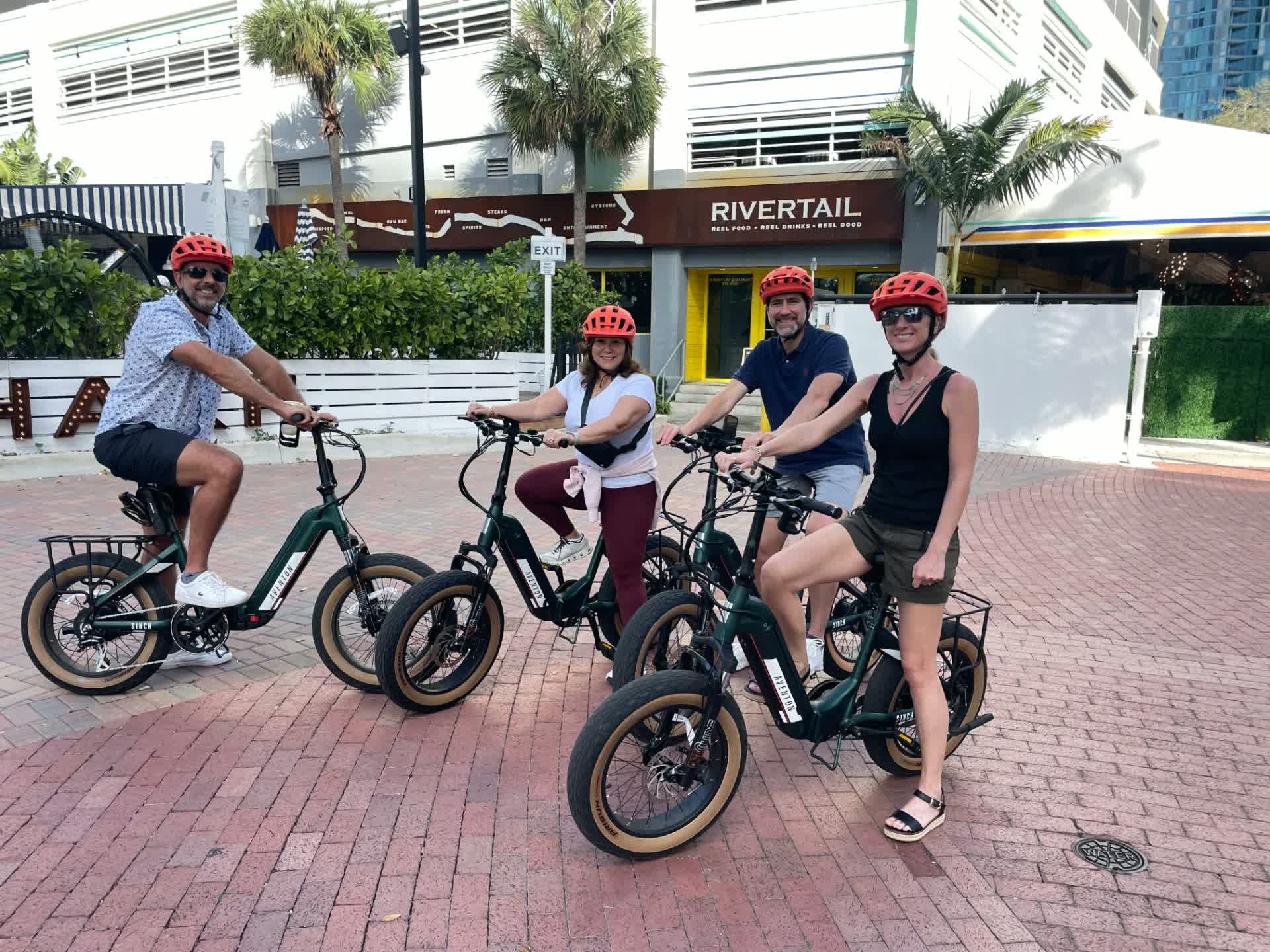 Four riders on Aventon Sinch eBike rentals outside Rivertail in Fort Lauderdale