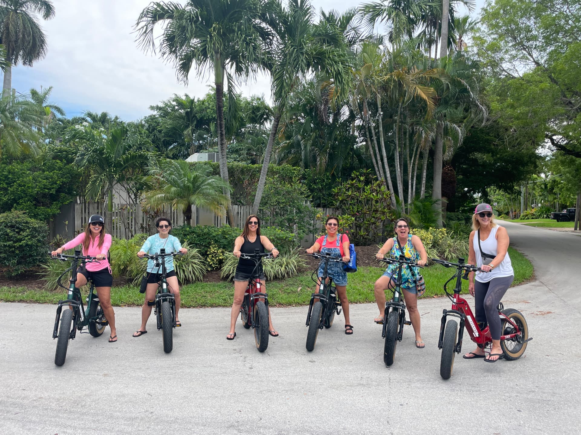 Group of six friends on EzeBike electric bike rentals in a Fort Lauderdale neighborhood